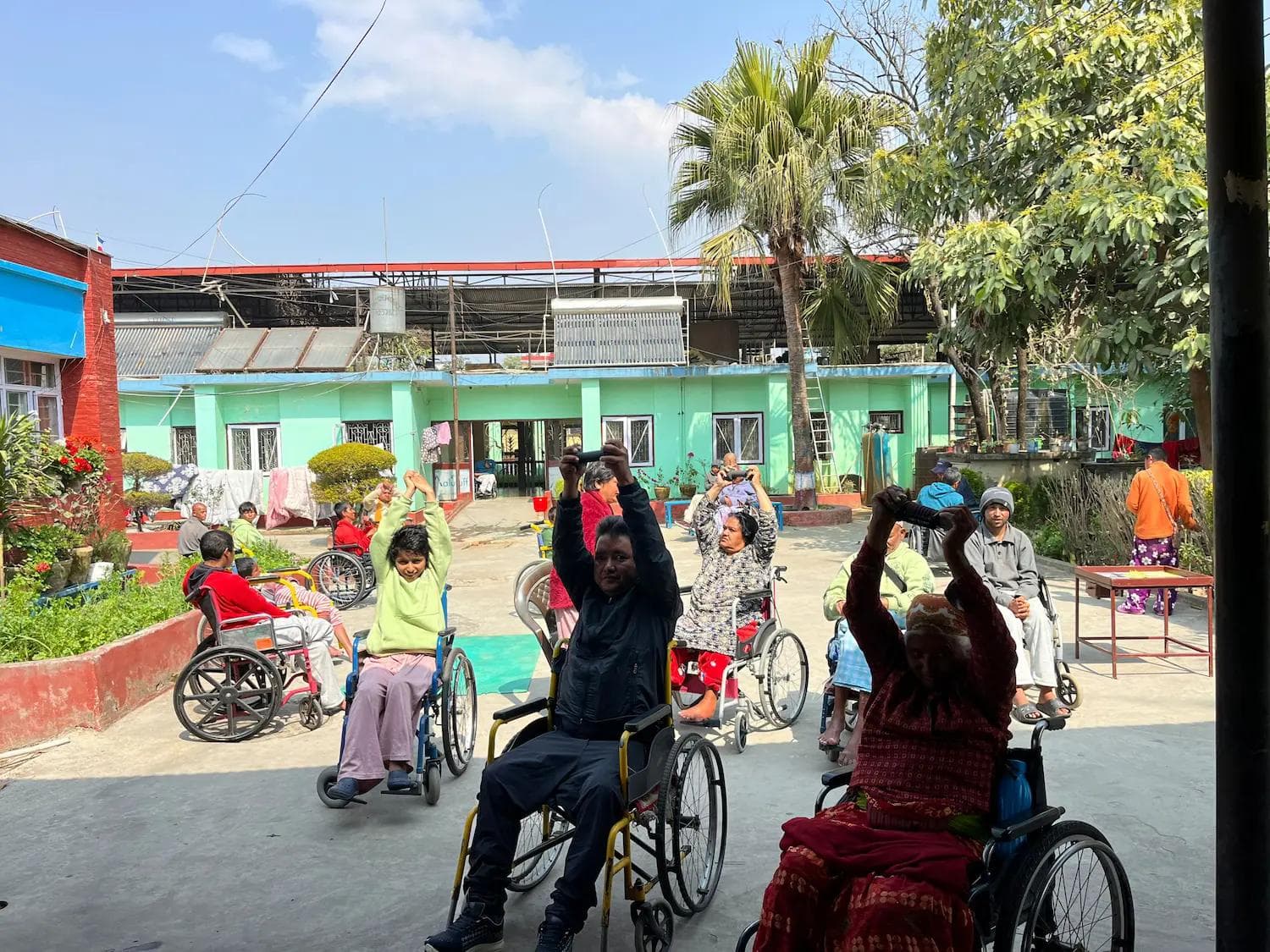 Physiotherapy volunteer leading a group exercise session for residents in Kathmandu, Nepal
