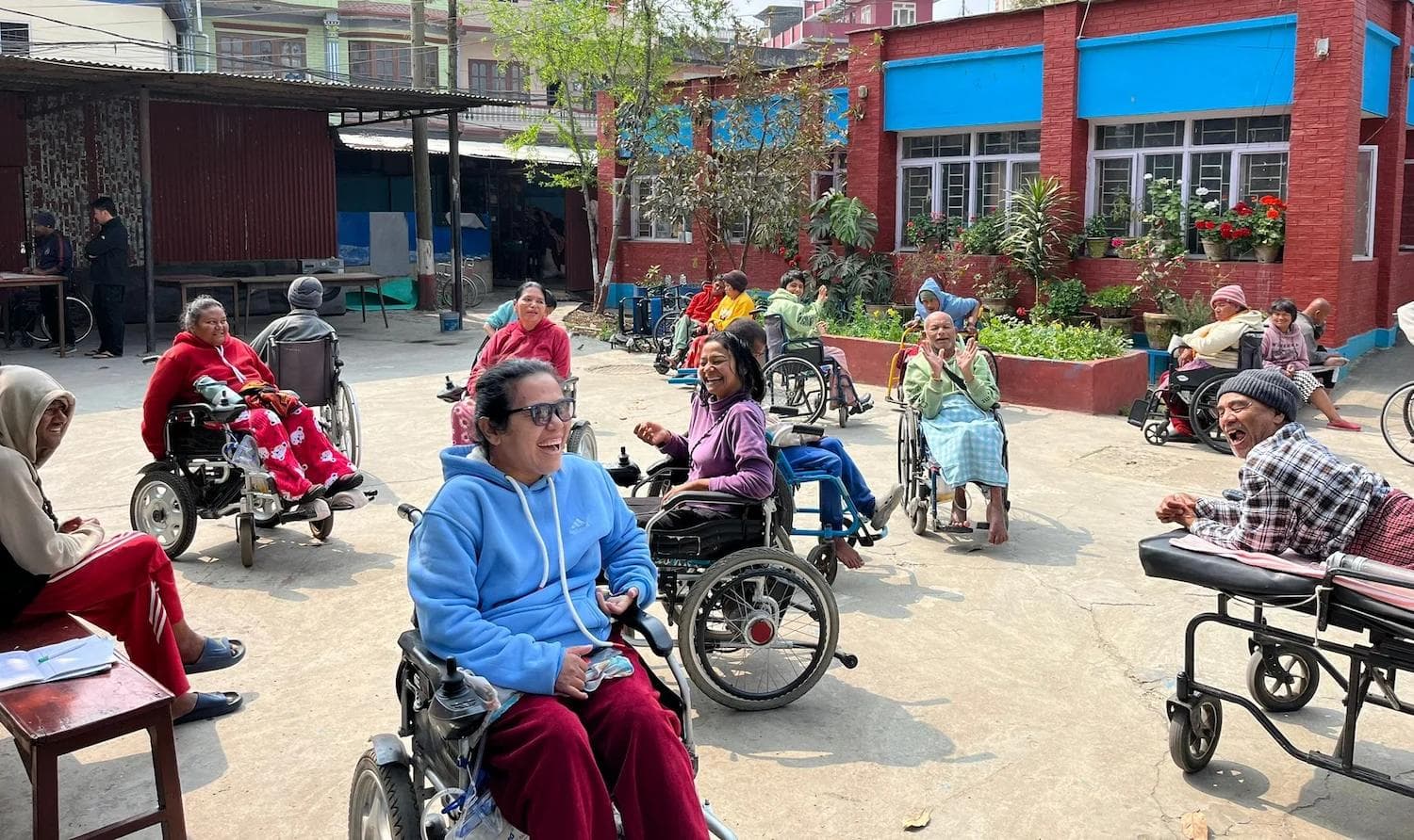 Physiotherapy volunteer helping a resident with exercises at the Khagendra New Life Home in Kathmandu, Nepal